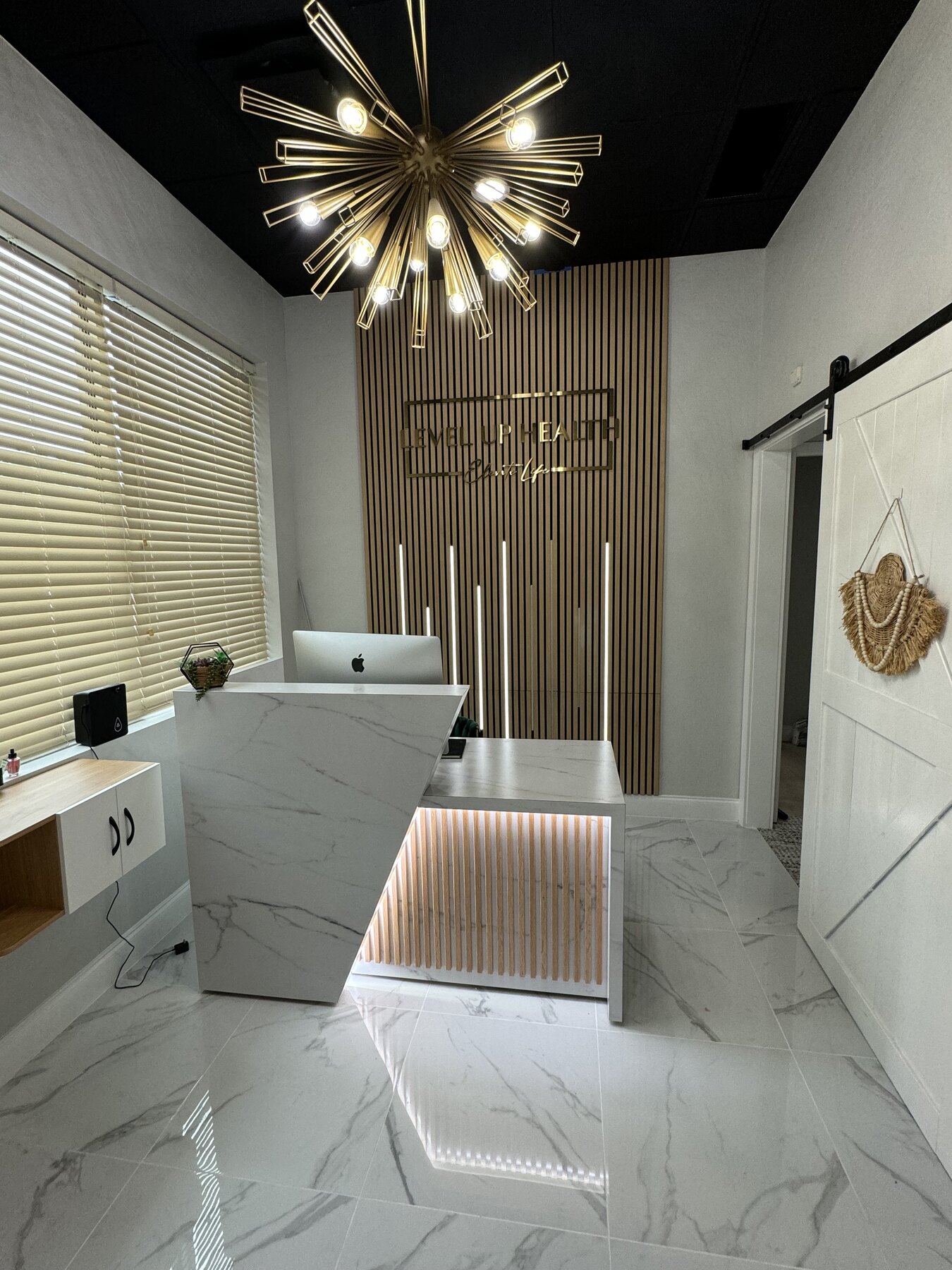 Level Up Health reception desk with illuminated wood details